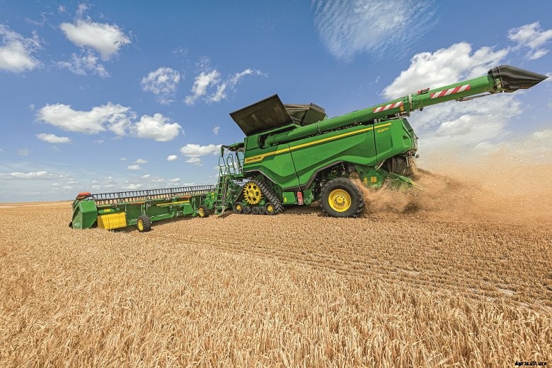John Deere X9 combine harvesting side view